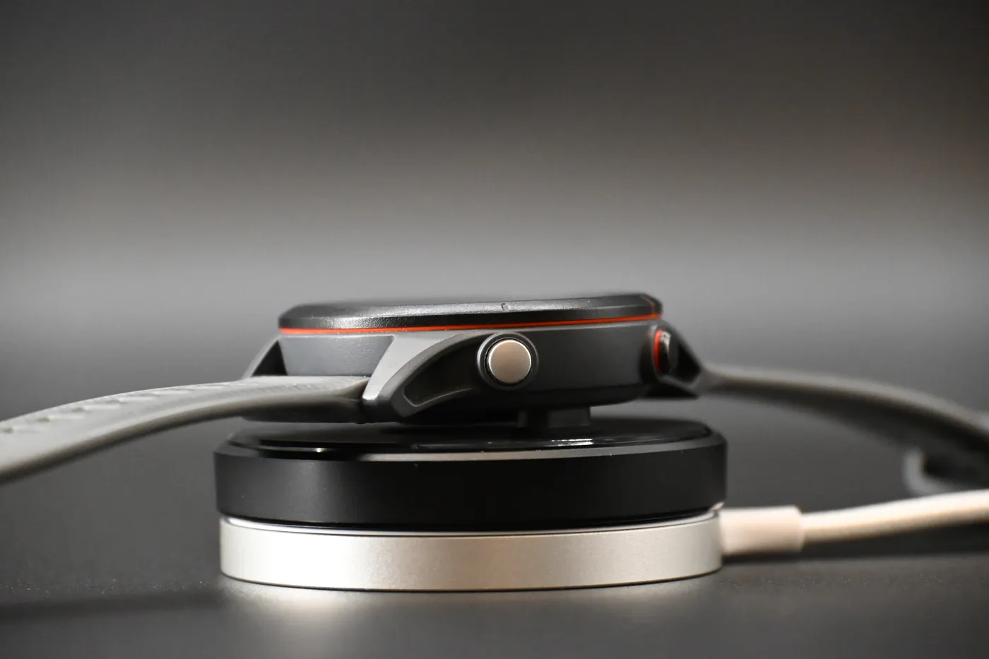 Low-angle view of a Garmin watch on the adapter and magnetic charger