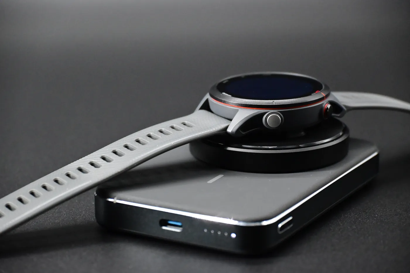 Garmin watch on the adapter stacked on a wireless power bank