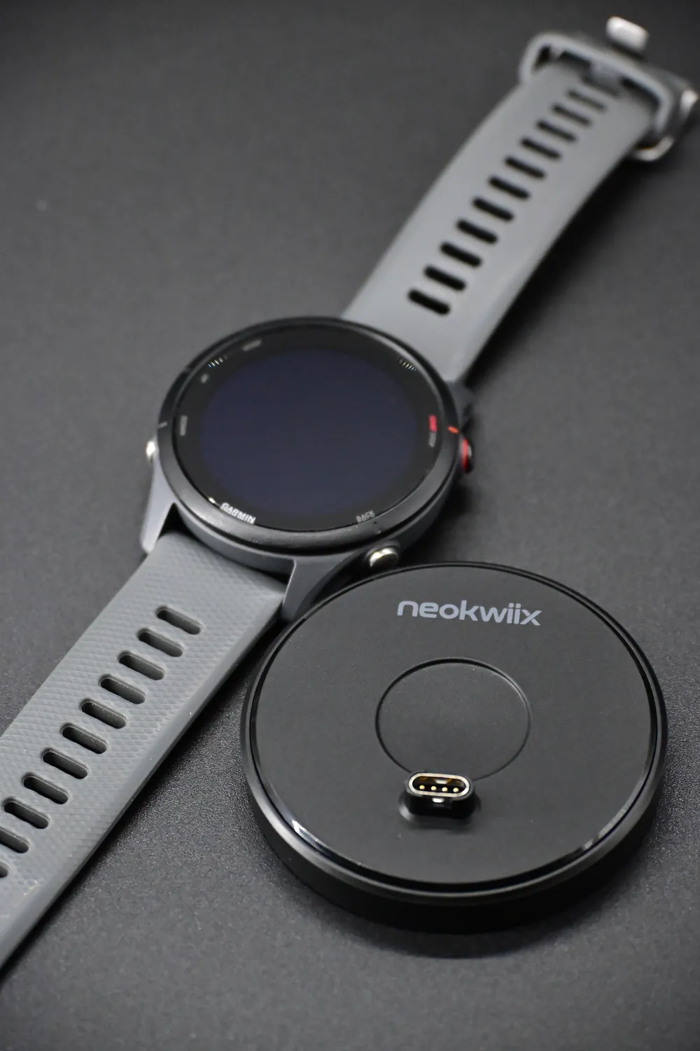 Top view of a Garmin watch and the adapter